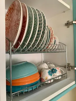 a plate rack with plates and bowls on it at BUDVA LUX in Budva