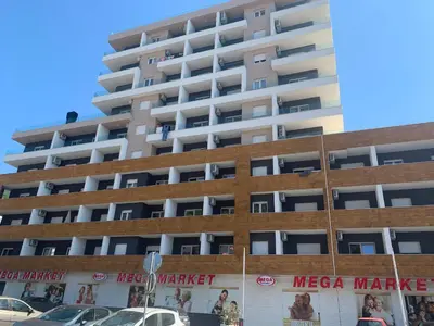 a large white building with posters on it at BUDVA LUX in Budva