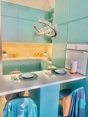 a kitchen with blue cabinets and a counter with plates on it at BUDVA LUX in Budva