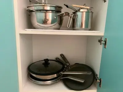 a shelf with pots and pans in a kitchen at BUDVA LUX in Budva