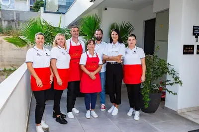 a group of people in aprons posing for a picture at APARTMENTS MERLIN in Dobra Voda