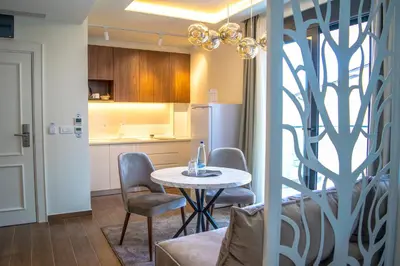 a kitchen with a table and chairs in a room at APARTMENTS MERLIN in Dobra Voda