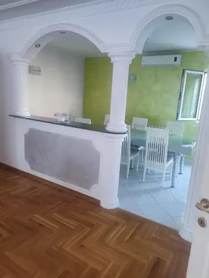 a room with a counter and a table and chairs at VILA LUKA in Podgorica