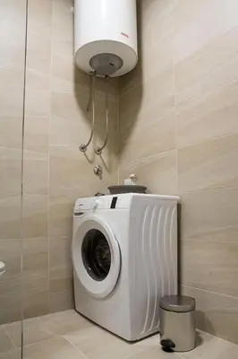 a washing machine in a bathroom with a light at Mina Studio Apartment Budva in Budva