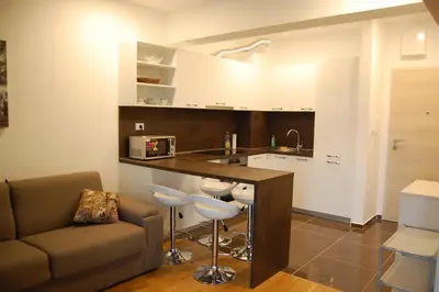 a living room with a couch and a kitchen at Status-M Apartments 152 in Becici