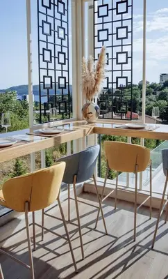 a dining room with a table and two chairs at Status-M Apartments 152 in Becici