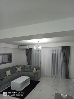 a living room with a couch and a table at ATA APARTMANI. in Petrovac na Moru