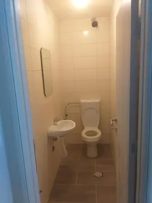 a small bathroom with a toilet and a sink at ATA APARTMANI. in Petrovac na Moru