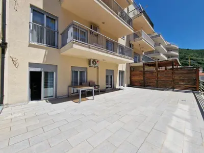 a large patio in front of a building at ATA APARTMANI. in Petrovac na Moru