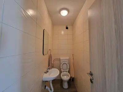 a small bathroom with a toilet and a sink at ATA APARTMANI. in Petrovac na Moru