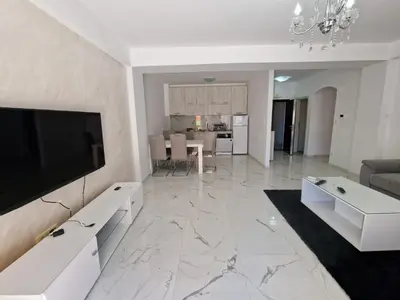 a living room with a flat screen tv on a wall at ATA APARTMANI. in Petrovac na Moru