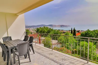 a balcony with a table and chairs and a view at VIVANA HOUSE in Bar, Susanj