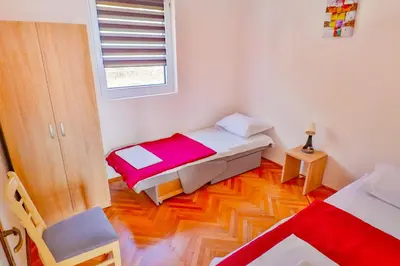a small room with two beds and a window at VIVANA HOUSE in Bar, Susanj