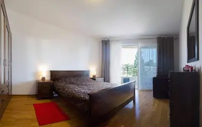 a bedroom with a bed and a large window at Apartment Ruzmarin Petrovac in Petrovac na Moru
