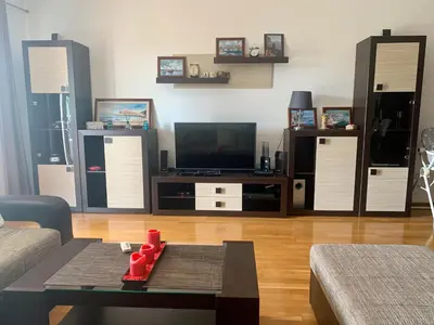 a living room with a couch and a tv at Apartment Ruzmarin Petrovac in Petrovac na Moru