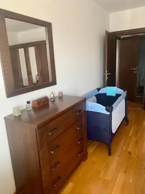 a bathroom with a dresser and a large mirror at Apartment Ruzmarin Petrovac in Petrovac na Moru