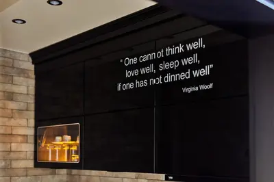 a wall with a fireplace with a sign on it at Apartment Lav in the City Centre in Kotor