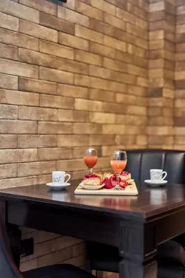 a table with two glasses of wine and food on it at Apartment Lav in the City Centre in Kotor
