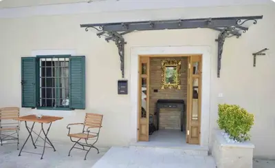 a patio with a table and chairs in front of a building at Apartment Lav in the City Centre in Kotor