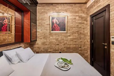 a bedroom with a bed with a plate of food on it at Apartment Lav in the City Centre in Kotor