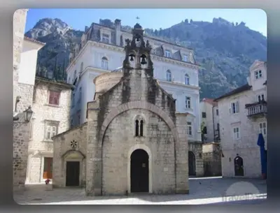an old stone building with a clock tower on it at Beautiful House Lara in Kotor