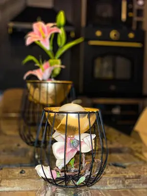 a candle in a glass bowl on a table with flowers at Beautiful House Lara in Kotor