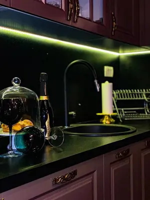 a kitchen counter with a sink and a bottle of wine at Beautiful House Lara in Kotor