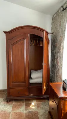 a large wooden cabinet with a bed in it at House in the Mountains near Budva in Budva