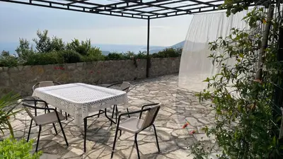 a white table and chairs on a patio at House in the Mountains near Budva in Budva