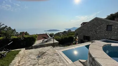 a villa with a swimming pool and a house at House in the Mountains near Budva in Budva