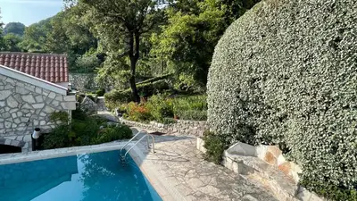 an overhead view of a swimming pool next to a wall at House in the Mountains near Budva in Budva