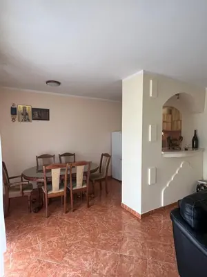 a kitchen and dining room with a table and chairs at Apartman Savo in Kotor