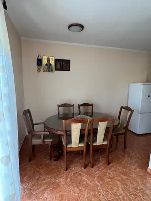 a dining room with a table and chairs and a refrigerator at Apartman Savo in Kotor