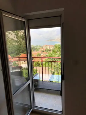 a sliding glass door with a view of a balcony at Apartman Savo in Kotor