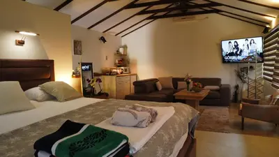 a bedroom with a bed and a living room at Apartman Livada Bar in Bar