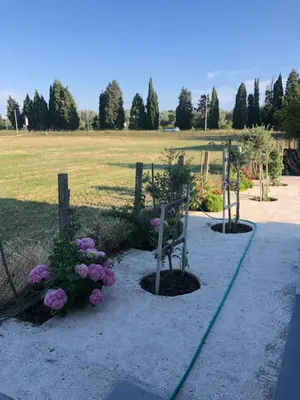 a garden with flowers and a fence and a field at Margaritaville in Ulcinj