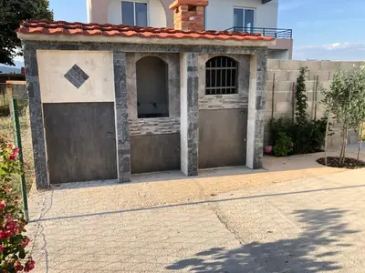 a pair of garage doors in front of a house at Margaritaville in Ulcinj