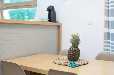 a pineapple sitting on top of a wooden table at Apartman DULY LUX in Pržno