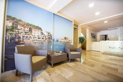 a lobby with a large window with a view of the water at Apartman DULY LUX in Pržno