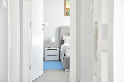 a bedroom with a bed and a blue rug at Verbalj apartment with swimming pool in Kotor