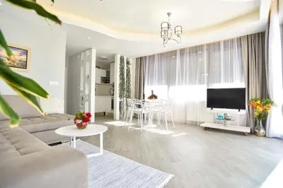 a living room with a couch and a table at Verbalj apartment with swimming pool in Kotor