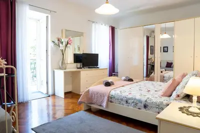 a bedroom with a bed and a mirror at M&B apartment in Kotor
