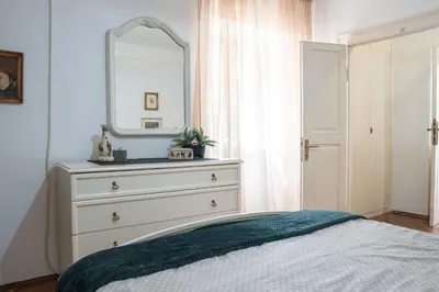 a bedroom with a dresser and a mirror at M&B apartment in Kotor