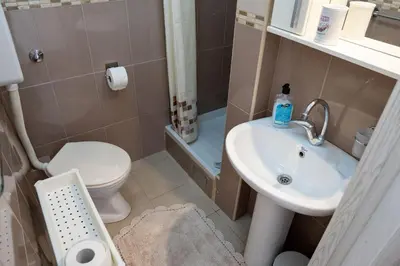 a small bathroom with a toilet and a sink at M&B apartment in Kotor