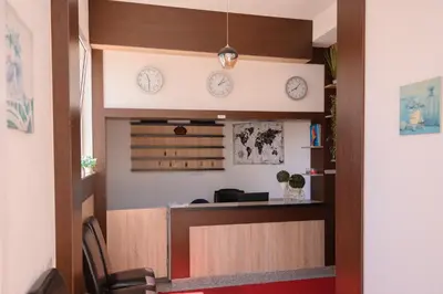 a waiting room with clocks on the wall at MS Hotel in Dobra Voda