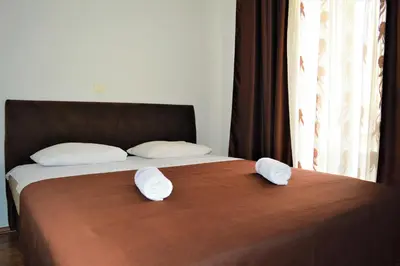 a bedroom with a bed with two pillows on it at MS Hotel in Dobra Voda