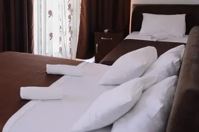 two beds with white pillows in a hotel room at MS Hotel in Dobra Voda