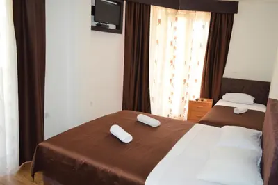 a hotel room with two beds with towels on them at MS Hotel in Dobra Voda