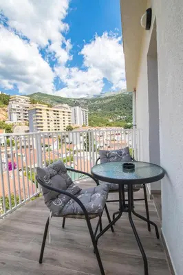 a table and chairs on a balcony with a view at Studio Apartment Urke in Budva