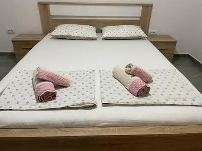 a bed with three pillows on it with at Villa Dafina in Donji Štoj